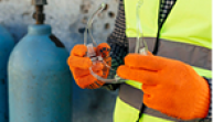 worker-with-gloves-holding-protective-glasses_23-2148773451 1